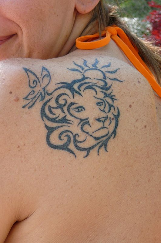 Gabriella - Lion, butterfly, sun tattoo